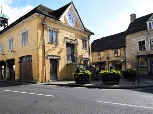 a building with a clock on the side of it at 1 bed property in Tetbury 79151 in Tetbury