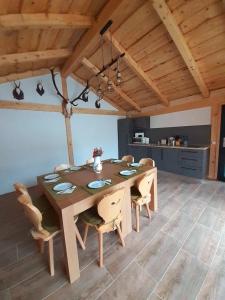 a dining room with a wooden table and chairs at Jagerhof in Râşnov