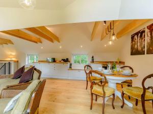 a kitchen and living room with a table and chairs at 2 Bed in Beverley 88422 in Lund