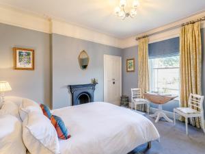 a bedroom with a large bed and a fireplace at 4 Bed in Darley Dale 79020 in Great Rowsley