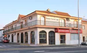 a building on the corner of a street at Hostal Puerto Lepe in Lepe
