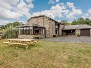 a stone house with a picnic table in front of it at 5 Bed in Brecon BN038 in Llanspyddid