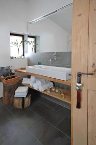 a bathroom with a sink and a mirror at Speckbacher Hof - Historisches Bauernhaus im Chiemgau in Unterwössen