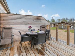 a patio with a table and chairs on a deck at 1 Bed in Sherborne 87916 in Bradford Abbas
