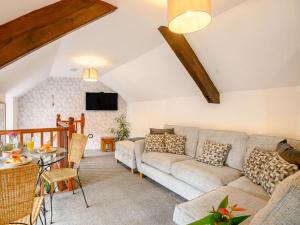 a living room with a couch and a table at 1 bed in St Briavels 88814 in Saint Briavels