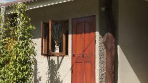 a dog sticking its head out the window of a house at Namas Kan Farmstay in Kanchanaburi