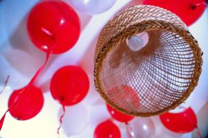 a red ornament hanging from a basket with red balloons at GOLDEN QUEST HOTEL in Entebbe