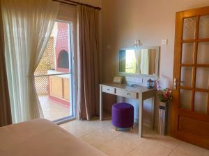 a bedroom with a desk and a mirror and a window at Lavender Homes, Walled City in Famagusta