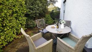 a table and chairs sitting on a patio at Misgrove House Annexe in Newton