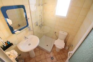 a bathroom with a sink and a toilet and a mirror at Oskar Hotel in Sarandë +129 photos