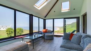 a living room with a view of the ocean at Caemor in Rhossili