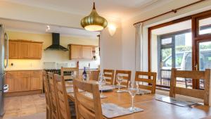 a kitchen and dining room with a table and chairs at Caemor in Rhossili