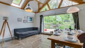 a living room with a table and a couch at Ship Cottage in Bishopston