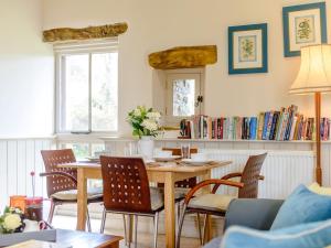 a dining room with a wooden table and chairs at 2 Bed in Crickhowell 42920 in Llangattock
