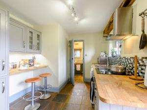 una cocina con encimera y taburetes. en 2 Bed in Crickhowell 42920, en Llangattock