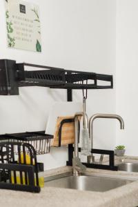 a kitchen counter with a sink and a kitchen sink at Villapadu Kota in Kuala Terengganu