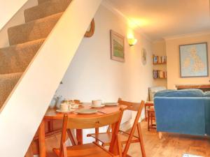 a dining room with a table and a staircase at 2 Bed in Appledore SALSP in Appledore