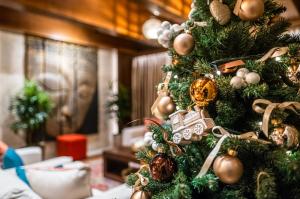 a christmas tree with ornaments on it at Mala Garden Design Hotel in Siófok