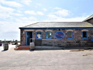 a brick building with a blue sign on it at 2 Bed in Montrose AN48M in Johnshaven