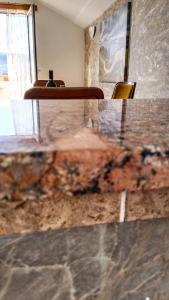 a marble counter top in a room with a window at Apartments "Belle Vue" in Herceg-Novi