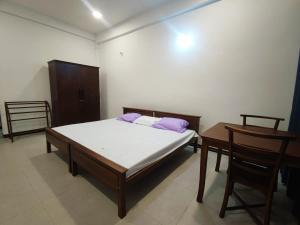 a bedroom with a bed and a table and chairs at Victoria Nature Resort in Digana