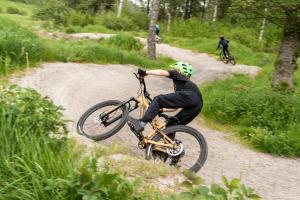 a man riding a bike on a dirt road at Lagunen Cottages and Hostel in Strömstad