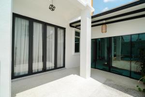 an external view of a house with large glass windows at Villapadu Kota in Kuala Terengganu