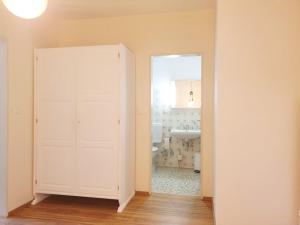 a bathroom with a white door and a sink at FeWo am Aeschacher Ufer in Lindau