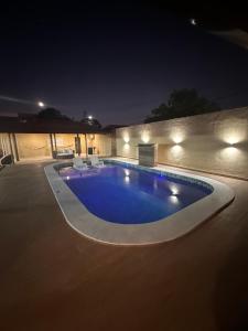 a swimming pool in a yard at night at aconchegoreceptivo in Marechal Deodoro