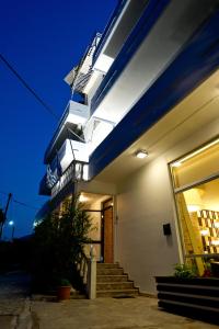 a building with stairs leading up to it at night at Dimitropoulos Seafront Apartments-Elaionas Beach near Diakopto in Eleonas