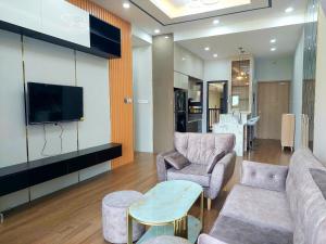 a living room with a couch and chairs and a tv at CĂN HỘ CAO CẤP CÓ SÂN VƯỜN TẠI BIÊN HÒA in Bien Hoa