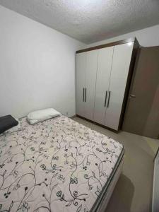 a bedroom with a bed and a cabinet in it at Casa de 2 quartos toda mobiliada in Brasilia