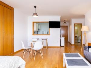 a living room with a table and white chairs at Home2Book Charming Studio Santa Cruz City Views in Santa Cruz de Tenerife