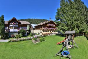 una casa grande con un patio con parque infantil en Ferienhof Kasparbauer, en Radstadt