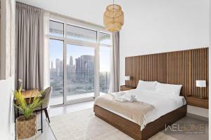 a bedroom with a bed and a large window at WelHome - Luxurious and Breathtaking Views 1BR in Za'abeel in Dubai