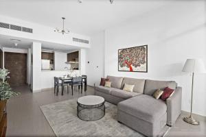 a living room with a couch and a table at WelHome - Luxurious and Breathtaking Views 1BR in Za'abeel in Dubai