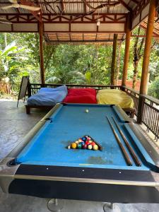 a pool table with cue balls on a patio at Nest Jungle in Kaôh Rŭng (3)