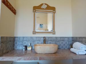 a bathroom with a sink and a mirror and towels at Villa Krini in Skiathos +106 photos