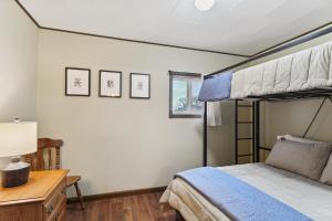 a bedroom with a bunk bed and a desk at Choteau Vacation Rental with Yard Walk to Downtown! in Choteau