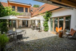 an outdoor patio with a table and chairs at OLLERS in Ollersdorf im Burgenland