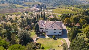 an aerial view of a large white house at Villa Godenano - Country Chianti Villa in Castellina in Chianti