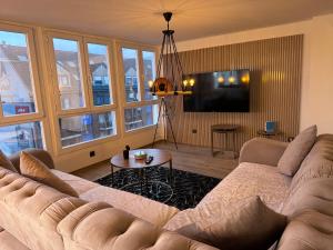 a living room with a couch and a tv at Penthouse wohnung ultra exlusive in Duisburg