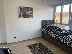 a bedroom with a bed and a window at Penthouse wohnung ultra exlusive in Duisburg