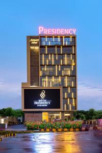 a building with a sign on the side of it at PRESIDENCY AIRPORT HOTEL in Cochin