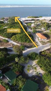 an aerial view of a road with a yellow arrow at Limbo Atins Chalets - Lençóis Maranhenses in Atins