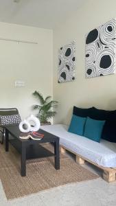 a living room with a couch and a table at Home Tales 1 - by Tipiverse in Bangalore