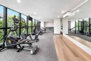 a gym with treadmills and exercise bikes in a building at Chic 1BR1B w BBQ, GYM, walk to Box Hill Central in Box Hill