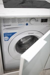 a white washing machine sitting in a room at Апартаменты в ЖК Каркын in Kostanay