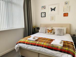 a bedroom with a bed with two butterfly pillows on it at Portland View - Spacious & Comfortable in Weston