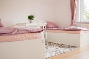 a room with two beds and a chair at Girls Willa in Kraków